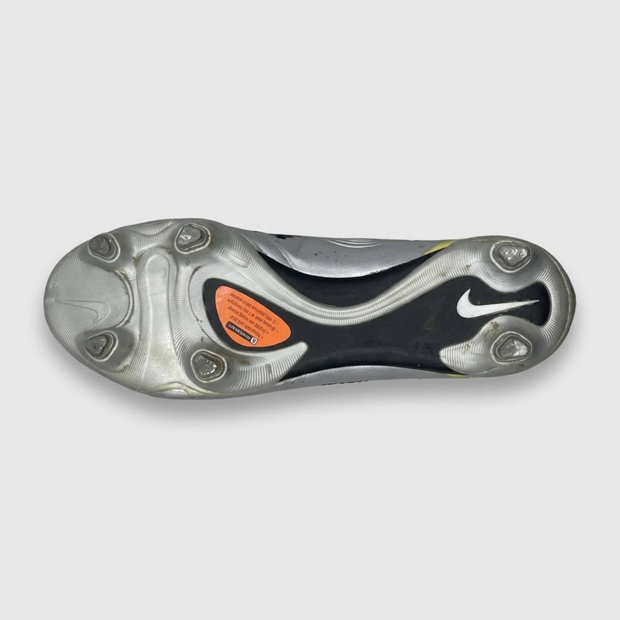 The boot's sole, silver with six studs